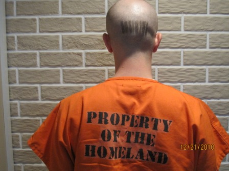 Man wearing shirt which reads 'property of the homeland'