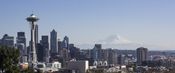 View of Seattle, including the Space Needle to the left and Mount Rainier in the distance.